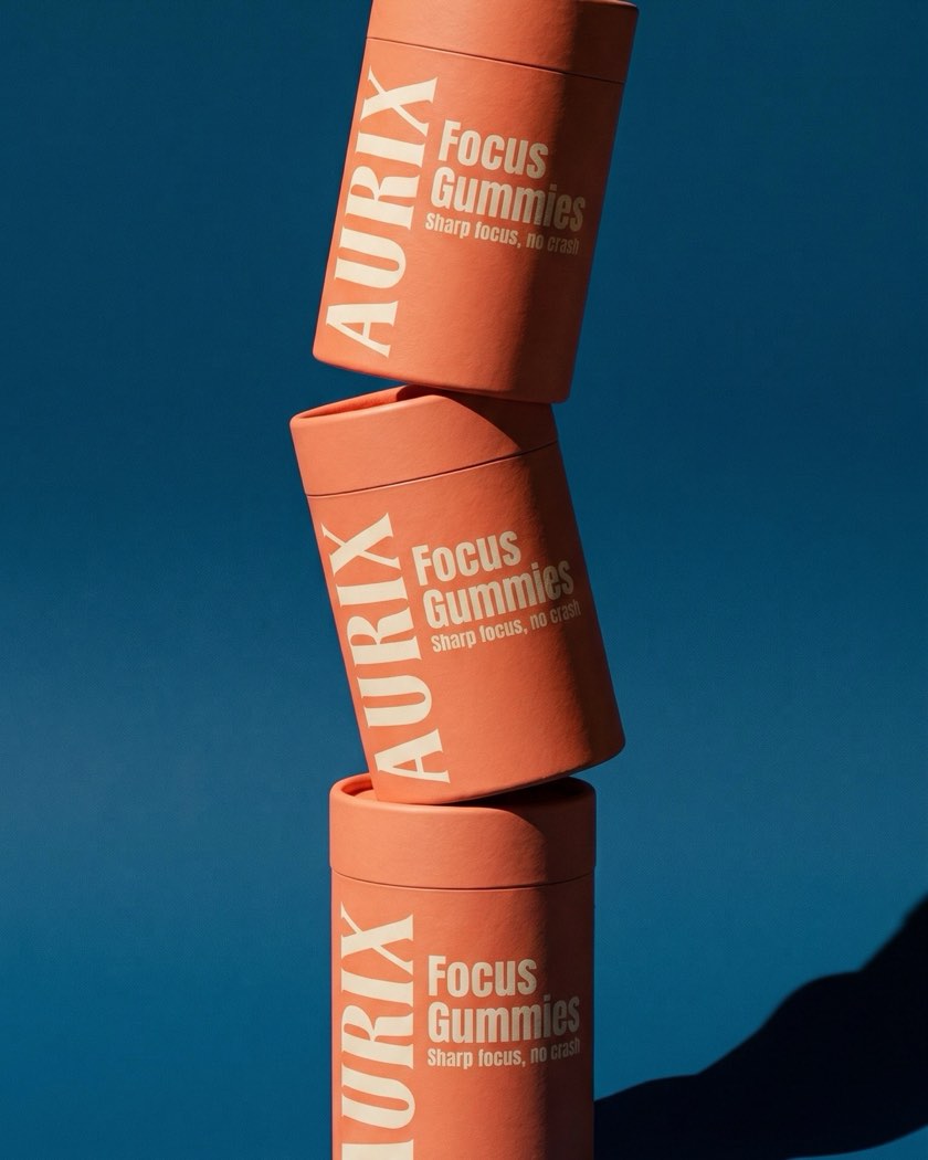 AURIX Focus Gummies tubes stacked against a blue backdrop